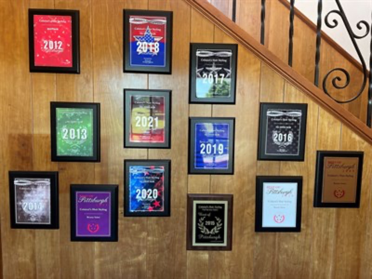 Colaizzi's salon awards wall — years of Best of Pittsburgh plaques